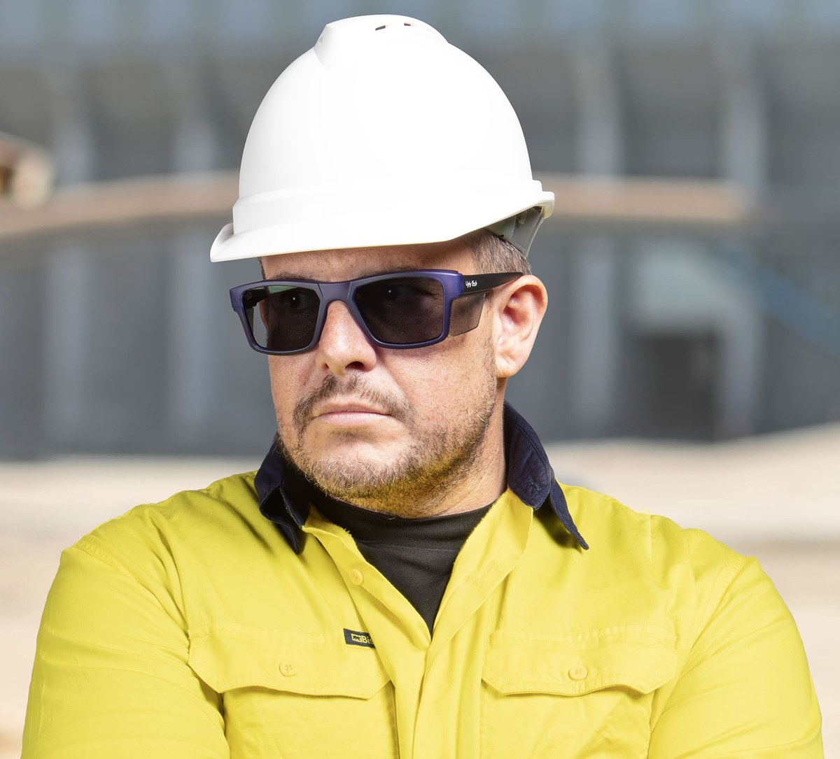 Worker is wearing Ugly Fish Jackal Tinted Sideshields Plastic Matt Black Prescription Safety Glasses