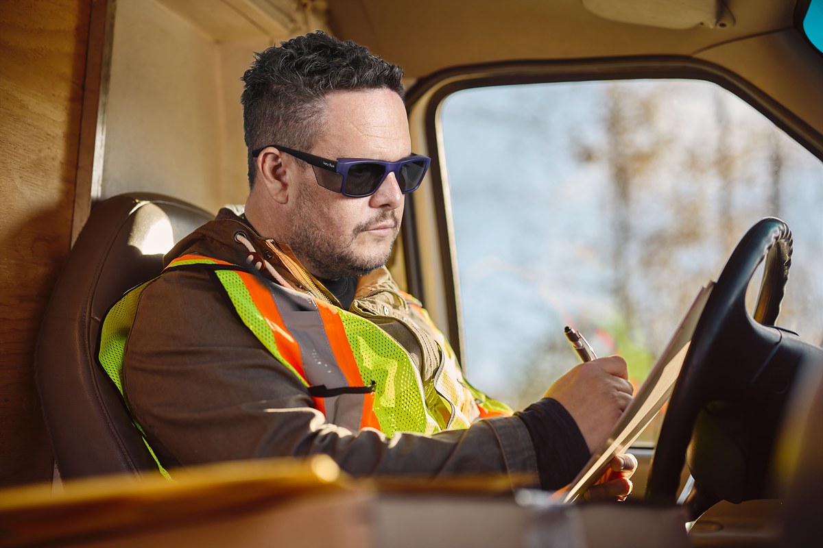 Worker is wearing Ugly Fish Jackal Large Plastic Frosted Blue Prescription Safety Glasses