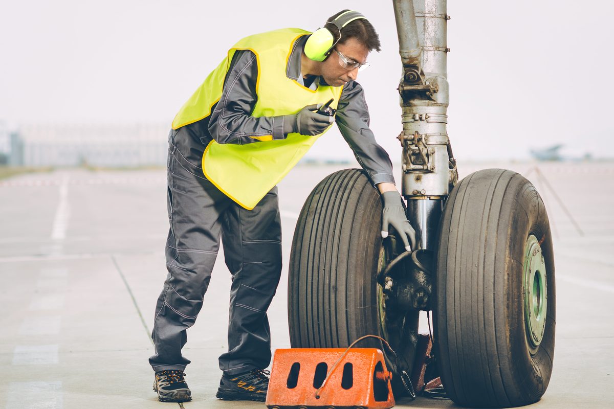 Aerospace worker wearing protective prescription safety glasses